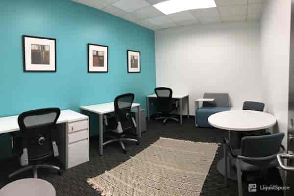 Modern meeting room with turquoise walls for collaboration in Long Beach.