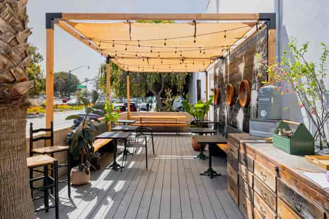 Stylish outdoor patio with wooden deck and string lights for events at The Wine Pub.