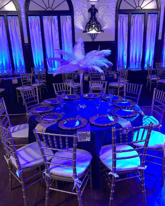 Elegant banquet table with feather centerpiece in Montebello Ballroom for weddings and galas.