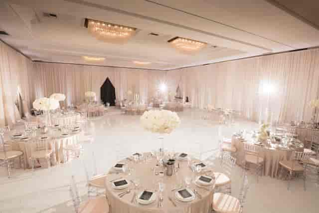 Elegant ballroom with floral centerpieces, perfect for weddings and corporate events.