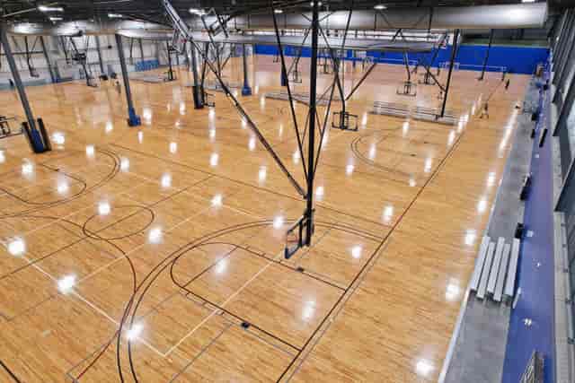 Spacious TBK Rehearsal Room 318 with polished wooden floor for sports events and tournaments.