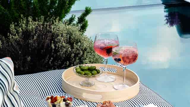 Stylish rooftop networking event at Knotel Workclub with elegant drinks and appetizers.