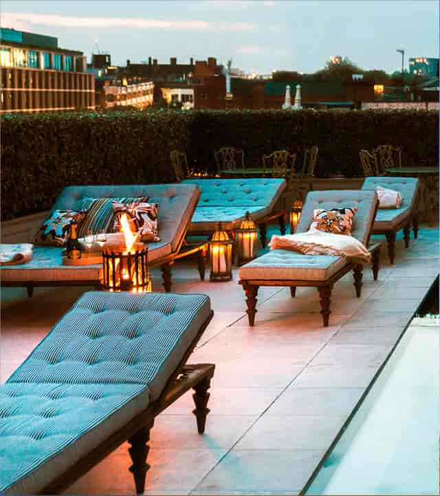 Stylish rooftop lounge with chaise lounges, perfect for networking events and receptions.