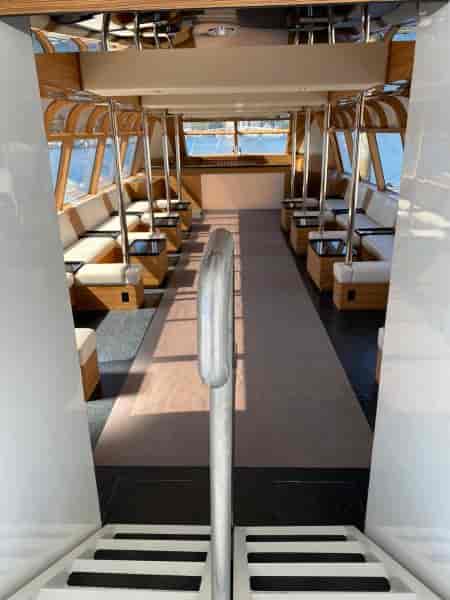 Modern boat event space with large windows for networking and gatherings.