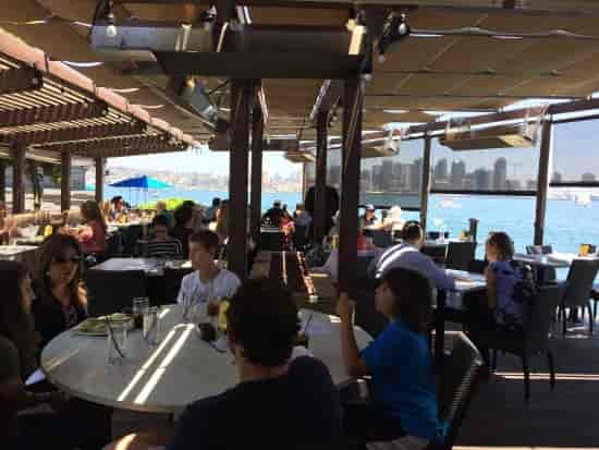 Vibrant outdoor dining patio at C Level Lounge, perfect for networking events by the waterfront.