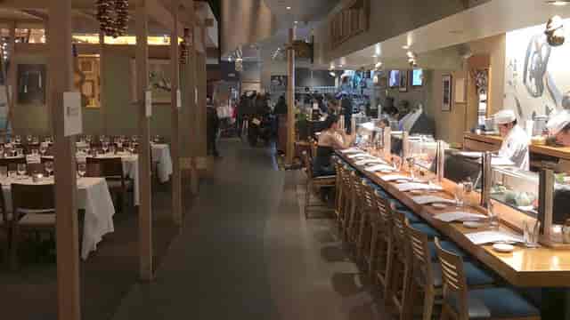 Semi-private dining area at Yoshi's with sushi bar, perfect for events and gatherings.