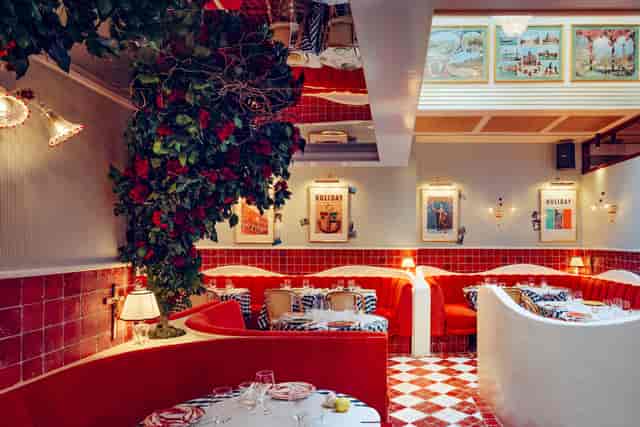 Vibrant cafe with red seating, perfect for intimate gatherings and upscale events.