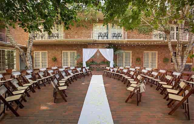 Outdoor courtyard at Horton Grand Hotel, ideal for weddings with elegant drapery and floral accents.