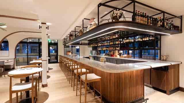Modern bar area in BE.STEAK.A, ideal for networking events and informal meetings.
