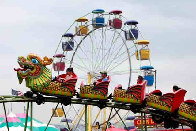Pepper Steak Hall at Santa Clara County Fairgrounds with colorful rides for family events.