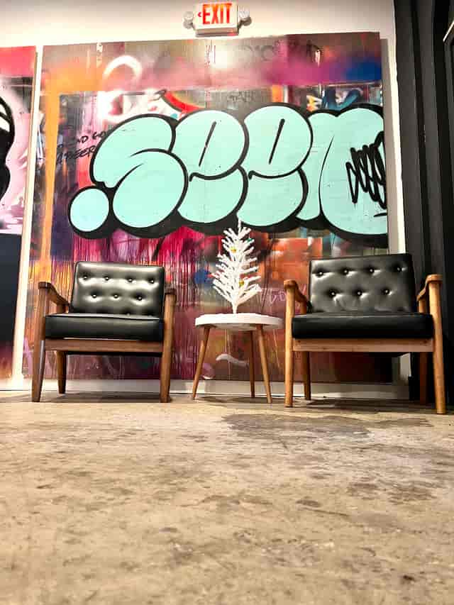 Stylish lounge with tufted chairs in urban creative office for networking events.