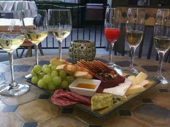 Charcuterie platter and wine glasses at Tessoras Campbell for networking events.