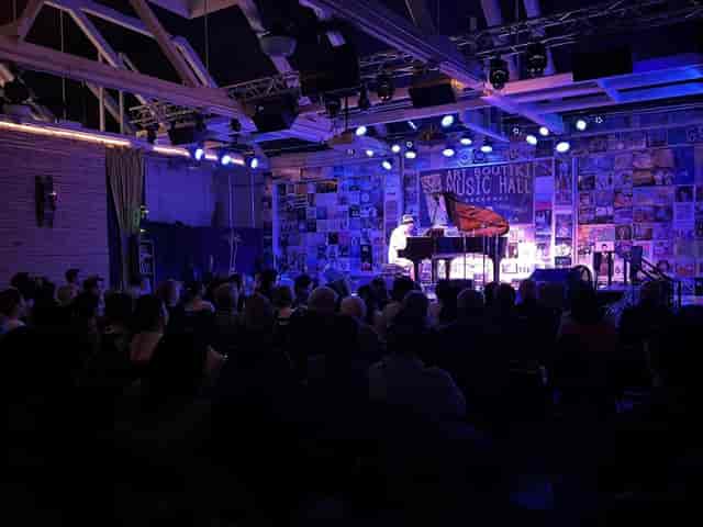 Vibrant event space with warm lighting for live performances and corporate gatherings.