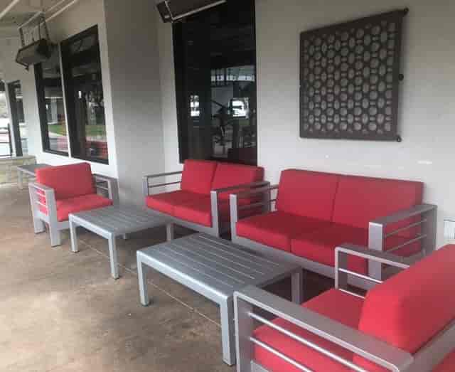Semi-private outdoor dining area with red sofas at Rock Bottom Brewery, ideal for networking events.
