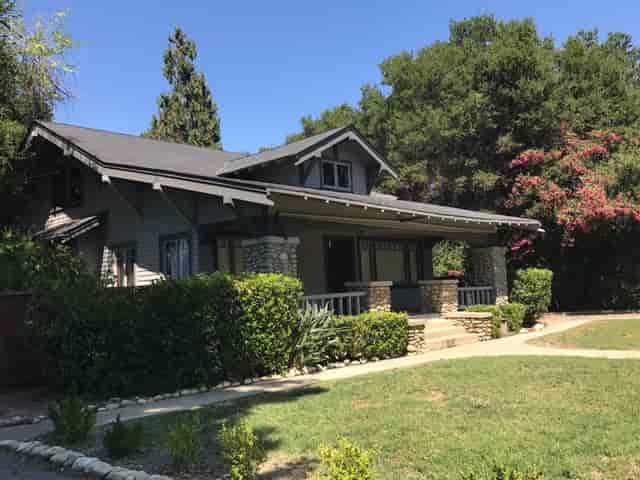 Charming Brookside Clubhouse with spacious porch, ideal for outdoor events and retreats.