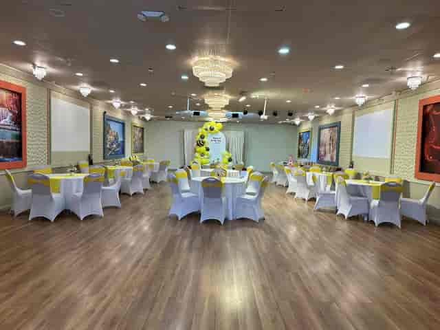 Moonlite Center banquet hall with round tables and elegant chandeliers for events.