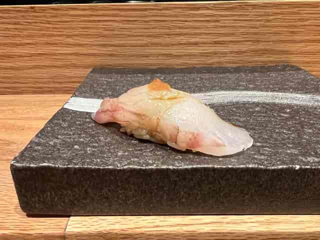 Elegant sushi on stone plate, perfect for upscale events and networking.