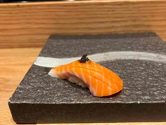 Elegant sushi presentation on a stone plate for upscale culinary events.
