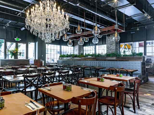 Stylish Oren's Hummus restaurant with elegant chandelier, perfect for events and gatherings.