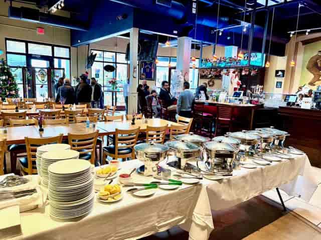 Vibrant patio event space with buffet stations for networking and socializing.