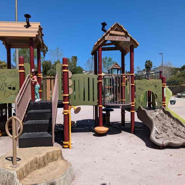 Colorful playground at Park de la Cruz Gymnasium for family-friendly events and gatherings.