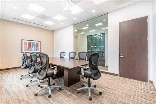 Modern conference room with spacious table and ergonomic chairs for collaborative meetings.