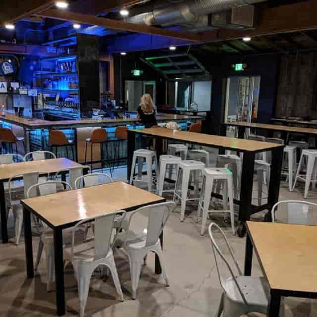 Modern bar setup in versatile event space for networking and casual gatherings.