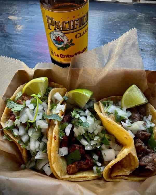 Vibrant tacos with onions and cilantro at Gringas Tacos for events and catering.