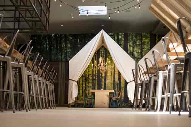 Private tents in forest venue for networking events and intimate dinners.