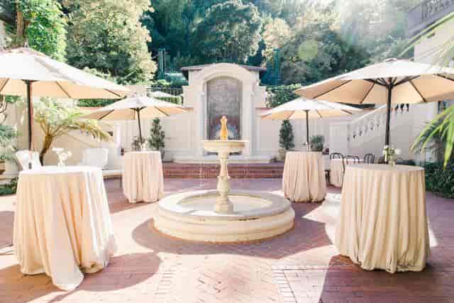 Spanish Courtyard at Montalvo Arts Center, elegant outdoor event space with cocktail tables.