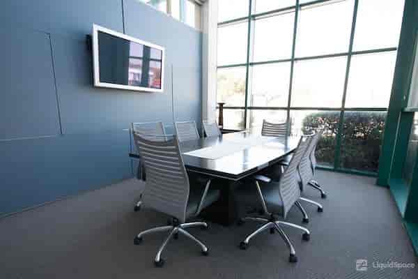 Modern conference room with large table and ergonomic chairs in Silicon Valley Business Center.