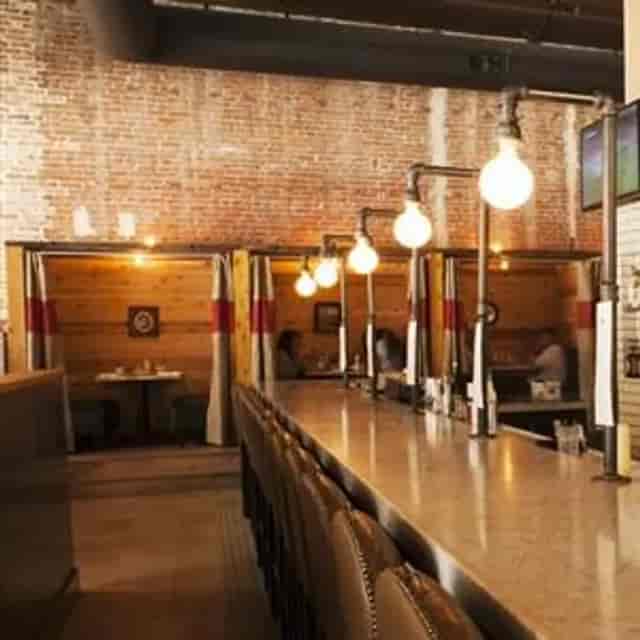 Stylish restaurant interior with rustic brick walls, ideal for networking events.