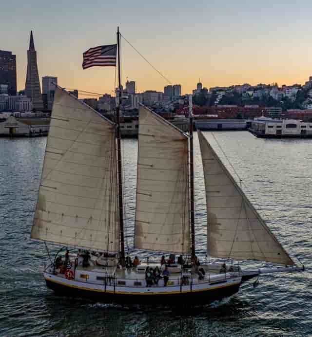 72-foot Tall Ship sailing at sunset, perfect for corporate retreats and networking events.