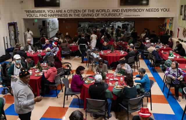 Senior community gathering with red tablecloths, fostering connection and support.