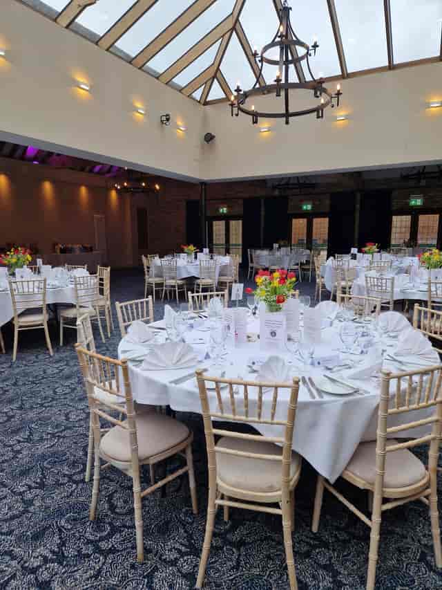 Hazel Suite at Voco Lythe Hill Hotel, elegant event space with floral centerpieces.