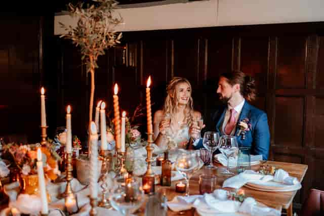 Intimate wedding reception in The Oak Room, Voco Lythe Hill Hotel & Spa, elegant decor.