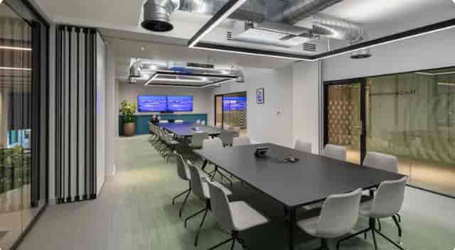 Modern meeting room with sleek table, ideal for corporate events and collaboration.