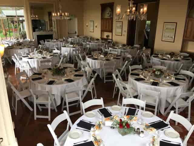 Elegant bar setup with round tables for weddings and corporate events.