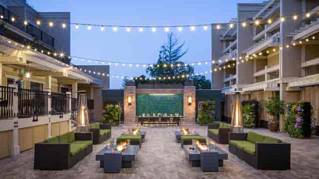 Courtyard at Toll House Hotel: inviting outdoor event space with string lights for gatherings.
