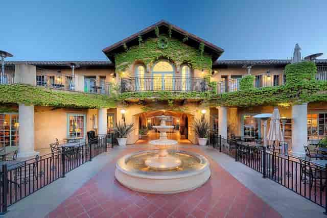 Charming Dio Deka Restaurant courtyard with lush greenery, ideal for weddings and events.