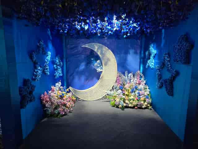 Enchanted Forest event space with crescent moon centerpiece, ideal for weddings and parties.