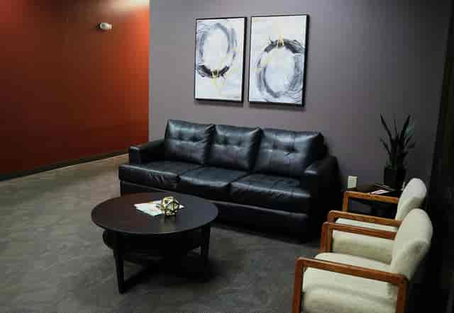 Private cubicles in Wave Tech Center with modern couch for networking and meetings.