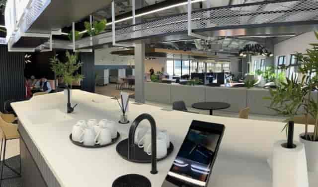 Modern serviced office meeting space with sleek kitchen, ideal for networking events.