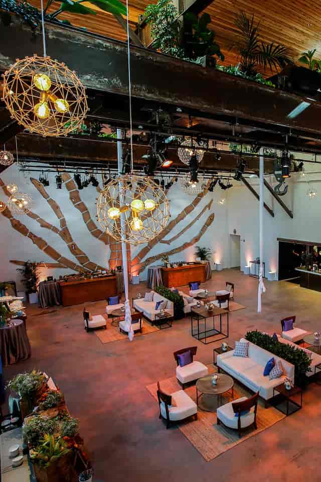 Elegant event venue with geometric chandelier, perfect for gatherings and receptions.