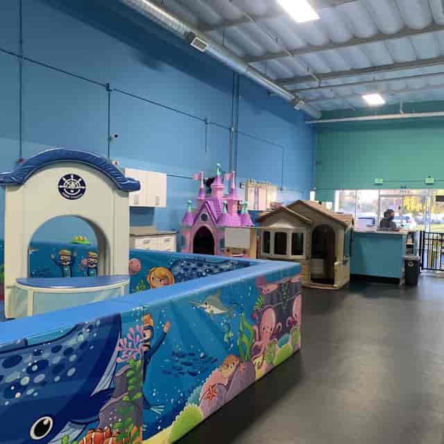 Vibrant party room with colorful play structures for children's birthday events.