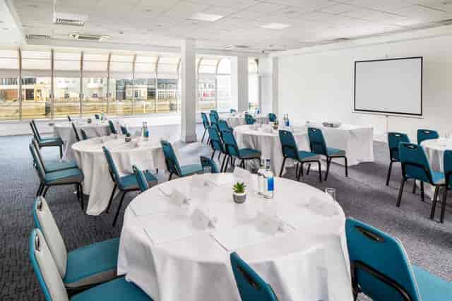 Pilgrim Suite meeting space with elegant tables, ideal for professional events and presentations.