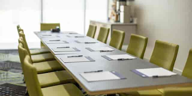 Carmel Boardroom at Holiday Inn San Jose, modern meeting space with green chairs.