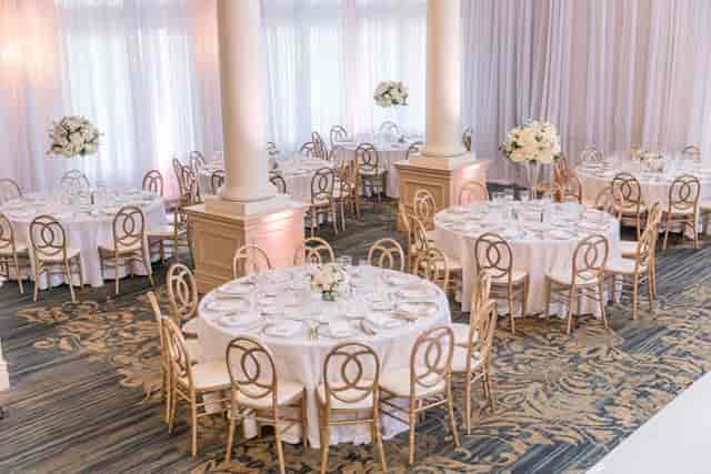 Elegant conference room with round tables, ideal for weddings and corporate events.