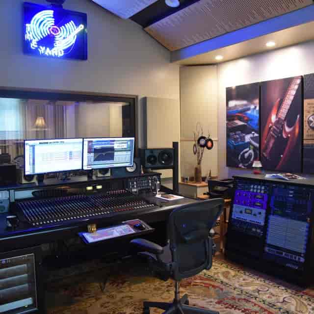 Modern audio recording studio with dual monitors, ideal for music production workshops.