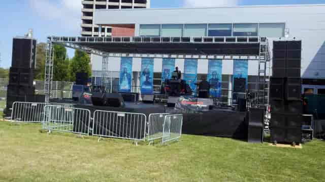 Outdoor event stage with sound system and lighting setup for Bay City Events.